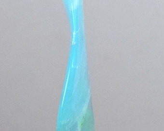 May include: A curved, elongated glass object with a gradient of colors. The top is a light blue, transitioning to a turquoise and then a pale green at the base. The object is smooth and appears to be translucent.