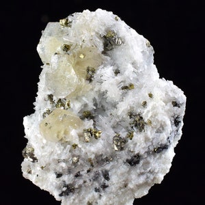 May include: A cluster of white quartz crystals with a yellow fluorite crystal and small, shiny pyrite crystals.