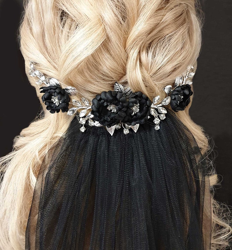 May include: Black bridal veil with a silver floral hair comb featuring black fabric flowers and rhinestones.