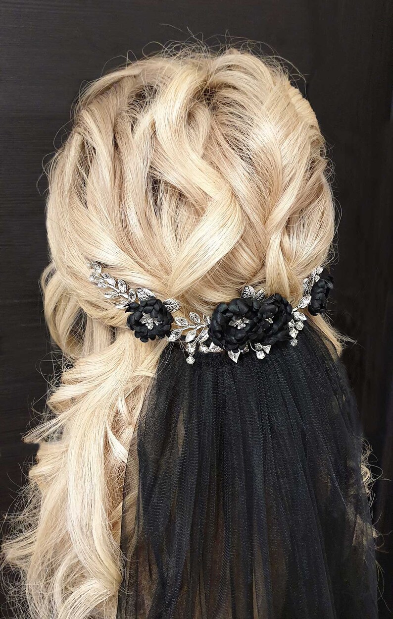 May include: Black bridal veil with a silver floral hair comb with black fabric flowers and rhinestones.