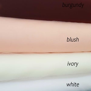 May include: Four swatches of tulle fabric in different colours: burgundy, blush, ivory, and white. The fabric is arranged in a stack, with the burgundy swatch on top and the white swatch on the bottom. The text "Veil colour" is written above the swatches.