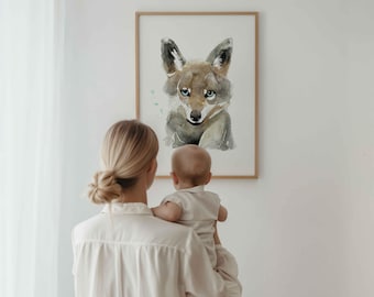 May include: A rectangular wall art print featuring a watercolor illustration of a fox with brown and gray fur, pointed ears, and blue eyes, set within a simple light-colored wooden frame against a plain white wall background.