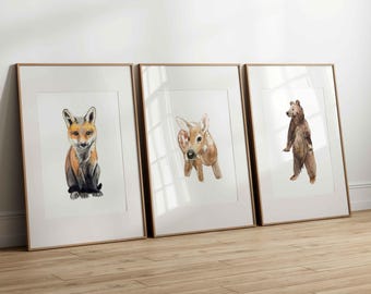May include: Three framed watercolor paintings of animals. The first painting features a fox, the second a deer, and the third a bear.