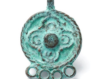 May include: A weathered, turquoise-colored pendant with a circular design. The pendant features a central raised circle and an outer ring with a floral pattern. Below the circle are five small, open circles. The pendant has a loop at the top for hanging.