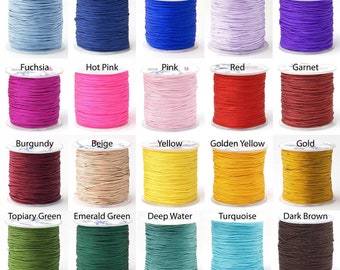 May include: A collection of spools of cord in various colors, including light blue, navy, blue, lavender, purple, fuchsia, hot pink, pink, red, garnet, burgundy, beige, yellow, golden yellow, gold, topiary green, emerald green, deep water, turquoise, dark brown, silver, white, and black.