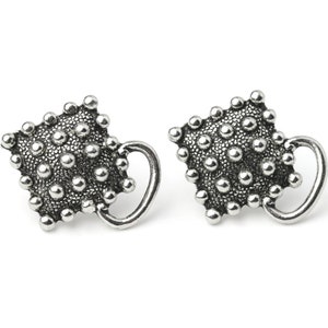 May include: A pair of silver-toned stud earrings. Each earring features a textured, square-shaped design covered in small, raised spheres. A curved, handle-like element extends from the side of each earring, creating a unique, artistic look.