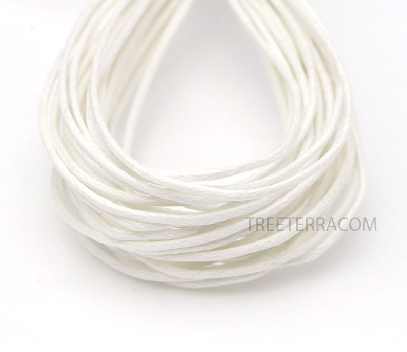 May include: Close-up of a bundle of white cotton cord. The cord is tightly wound, creating a layered effect. The texture appears soft and slightly textured. The image is well-lit, highlighting the cord's color and form. The website treeterra.com is visible.