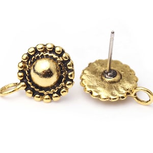 May include: Two antique gold-colored earring components. Each component features a central dome surrounded by a beaded border. A small loop is attached to the side, and a post is attached to the back of one component.