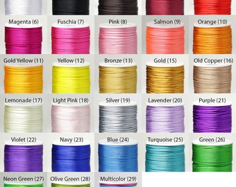 May include: A collection of spools of cord in various colors, including white, black, red, pink, and green. Each spool is labeled with a color name and a number. The cords appear to be made of a smooth, shiny material.