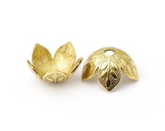 May include: Two gold-colored, flower-shaped bead caps. Each cap has a detailed petal design with a central hole. The caps are made of metal and are likely used for jewelry making or crafting.