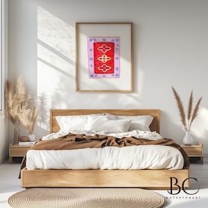 May include: A framed watercolor painting of a red and pink rug with a floral design. The painting is hanging on a white wall above a bed with brown bedding.