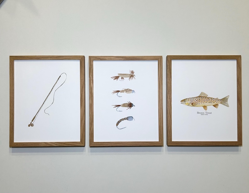May include: Three framed prints with a fishing theme. The left print shows a fishing rod and line. The center print shows five different fishing flies. The right print shows a brown trout with the text "Brown Trout" below it.