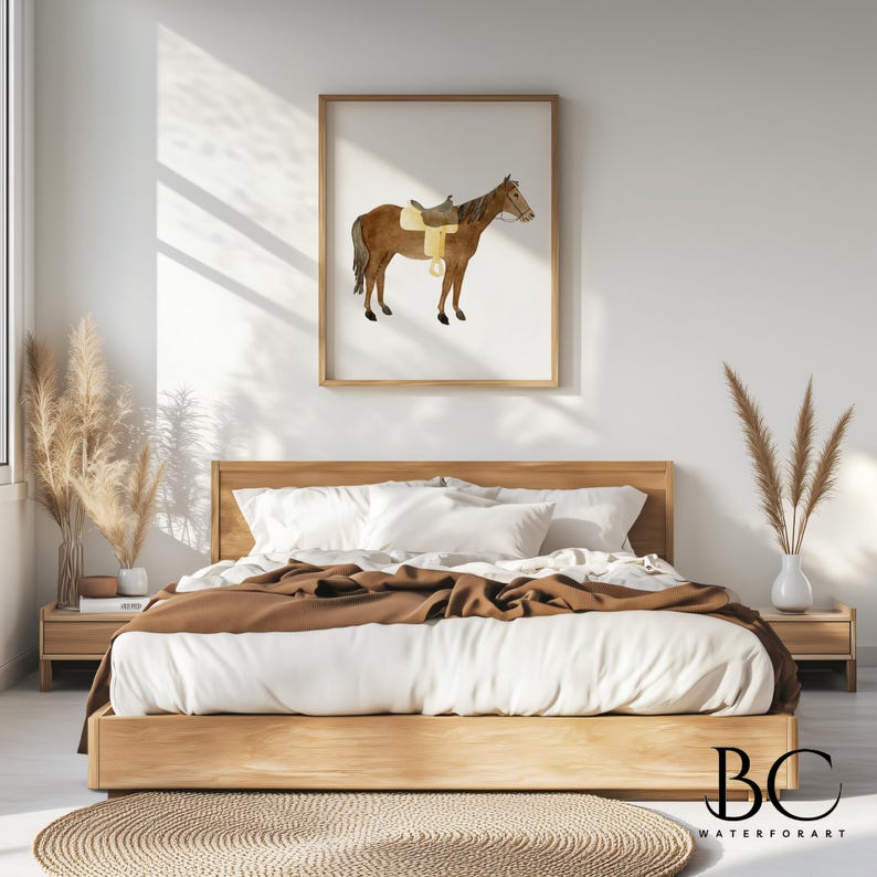 May include: A watercolor painting of a brown horse with a saddle, framed in a light wood frame and hanging on a white wall above a bed with brown bedding.