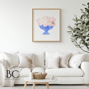 May include: A watercolour painting of a blue vase filled with pink flowers. The vase is on a white background.