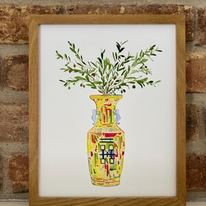 May include: A watercolor painting of a yellow vase with a colorful geometric pattern and green olive branches with small black olives.