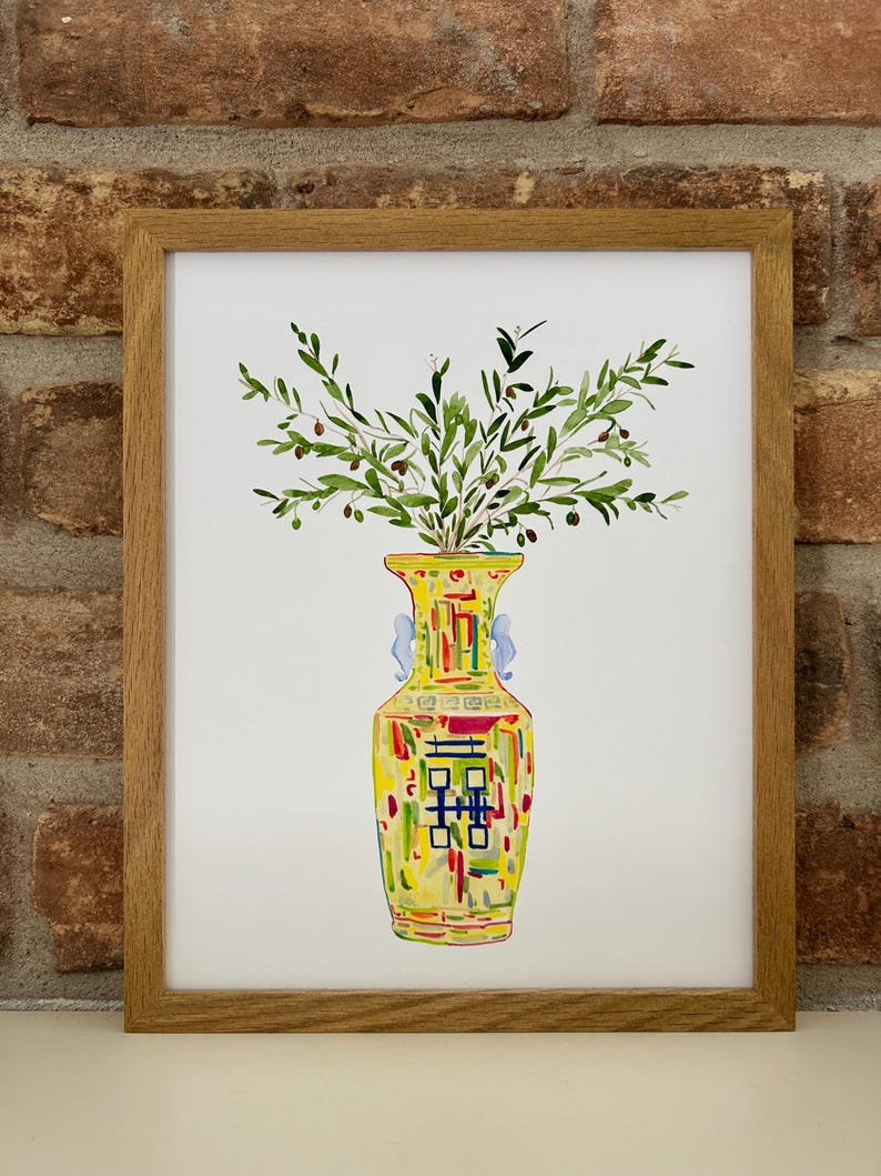 May include: A watercolor painting of a yellow vase with a colorful geometric pattern and green olive branches with small black olives.