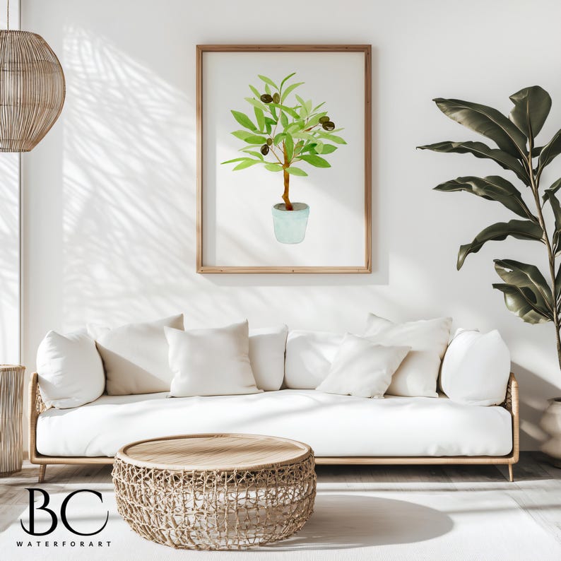 May include: A watercolour painting of a potted olive tree with green leaves and black olives. The painting is framed in a light wood frame and is hanging on a white wall.