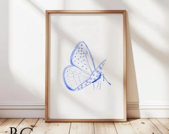 May include: A framed print of a blue watercolor butterfly with a white background. The butterfly is drawn in a simple, stylized manner.