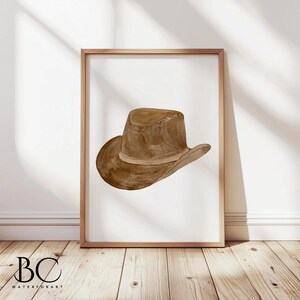 May include: A brown leather cowboy hat with a wide brim and a brown band. The hat is isolated on a white background.