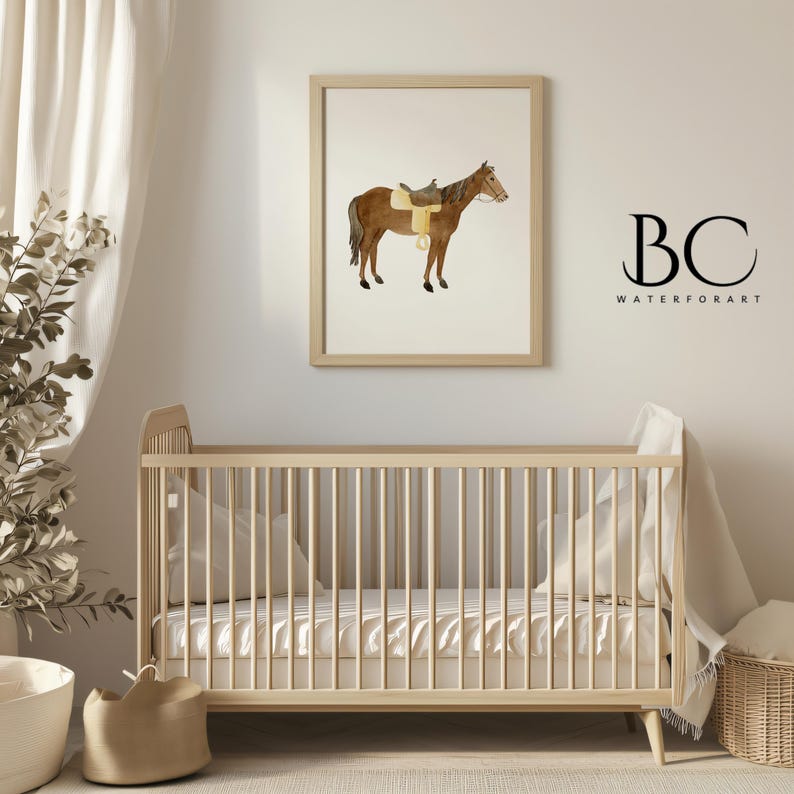 May include: A watercolor painting of a brown horse with a saddle and bridle. The horse is standing on a white background. The painting is framed in a light wood frame and is hanging on a white wall. A crib with white bedding is in the foreground.