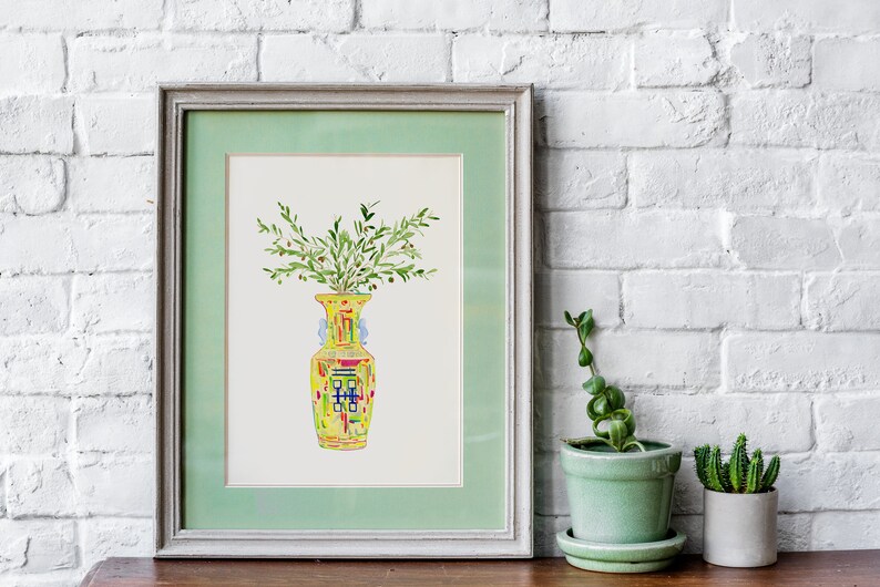 May include: A framed watercolor painting of a yellow vase with green leaves and red berries. The vase has a colorful geometric pattern.