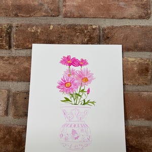 May include: A watercolor painting of a pink floral arrangement in a pink and white patterned vase. The flowers are pink with yellow centers and are arranged in a bouquet.