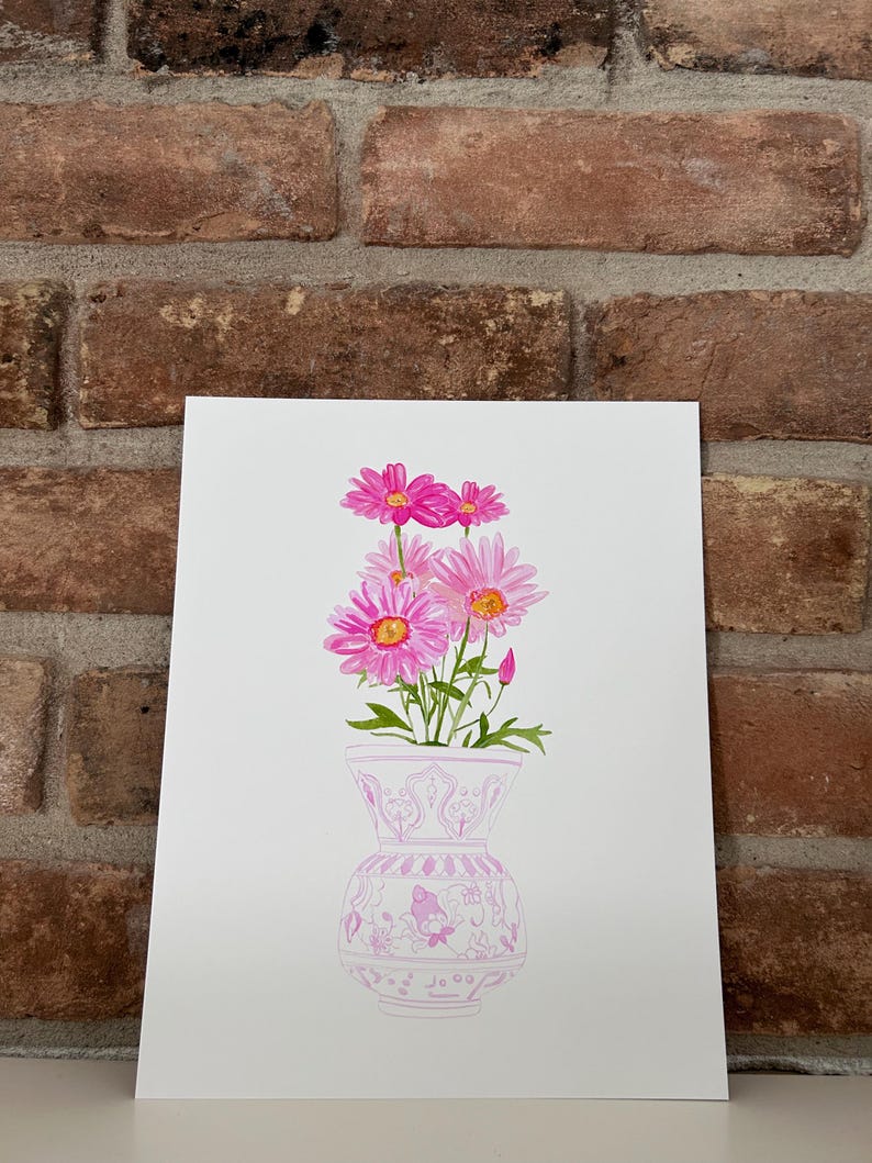 May include: A watercolor painting of a pink floral arrangement in a pink and white patterned vase. The flowers are pink with yellow centers and are arranged in a bouquet.