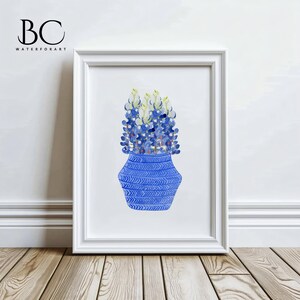 May include: A watercolor painting of a blue vase with a white and blue chevron pattern filled with blue and green Texas bluebonnets.