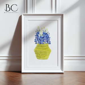 May include: A watercolor painting of a bouquet of bluebonnet flowers in a yellow vase with a chevron pattern. The vase is on a white background.