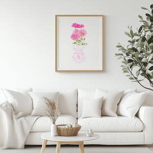 May include: A framed watercolor painting of pink flowers in a white vase with a pink floral pattern. The vase is on a white background.