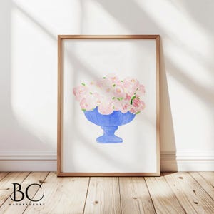 May include: A watercolour painting of a blue vase filled with pink flowers. The vase has a pedestal base and is painted in a light blue colour. The flowers are pink and white and are arranged in a loose, natural style.