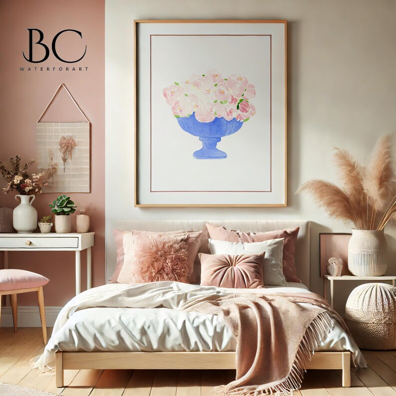 May include: A watercolour painting of a bouquet of pink roses in a blue vase, framed in a light wood frame, hanging above a bed with pink pillows and a white blanket. The painting is titled "BC WATERFORART".