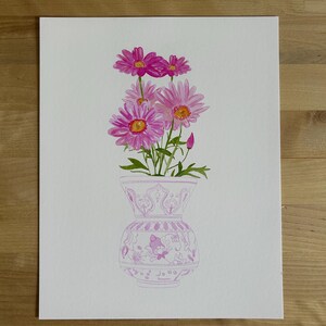 May include: A watercolor painting of a bouquet of pink daisies in a white vase with a pink floral pattern. The vase has a wide mouth and a round body.
