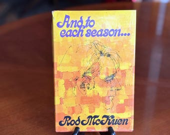 May include: A yellow and orange cassette tape case with a purple and white title "And to each season..." and the artist's name "Rod McKuen" in black lettering. The case features a black and white line drawing of a person's face.
