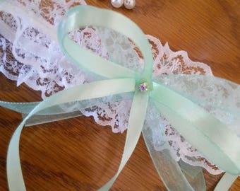 White or ecru lace garter and water-green ribbon