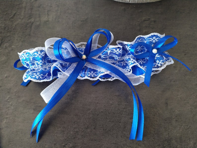 Pretty duo of white lace garters trimmed with royal blue satin ribbon bows image 2