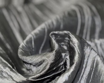 swatch of pleated crumpled taffeta fabric in metallic gray color
