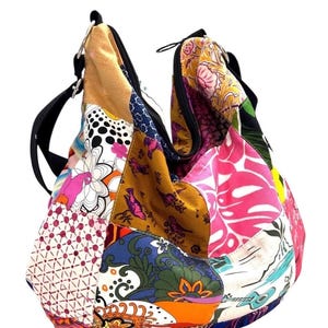 May include: A colourful patchwork shoulder bag with a black strap and zip. The bag is made from various patterned fabrics, including floral, geometric, and animal prints. A unique and vibrant accessory.