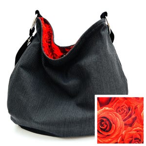 May include: A black and gray striped hobo bag with a red rose print interior. The bag has black straps and gold-colored metal rings. A small square inset shows a close-up of the red rose print.