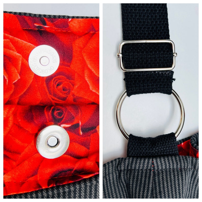 May include: Close-up of a tote bag with a red rose pattern lining and a magnetic snap closure. The bag features a black strap with a silver metal ring and buckle. The exterior fabric has a gray and black pinstripe design.
