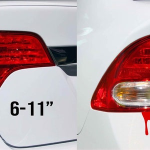 May include: Two white cars with red dripping paint decals on the back. The decals are shaped like blood drops. The text "6-11" and "3-5" are printed on the cars.