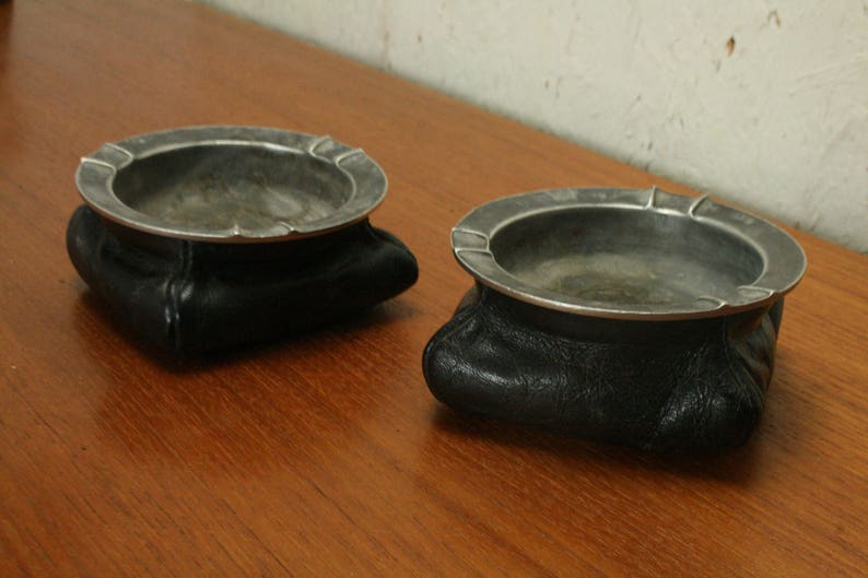 pair of vintage leather and pewter ashtrays
