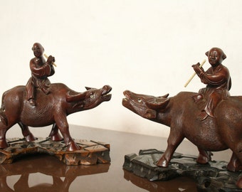 Vintage Chinese figures sat on water buffalo