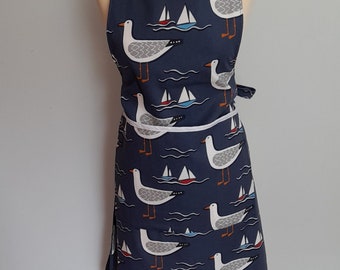 Organic cotton adult apron with patch pocket in Whitby Seagull design in navy