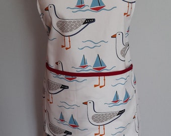 Organic cotton adult apron with patch pocket in Whitby Seagull design in white