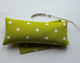 heat pack/ heat bag filled in wheat and organic lavender in a lime green dotty design.  Microwavable for relaxation and pain relief.