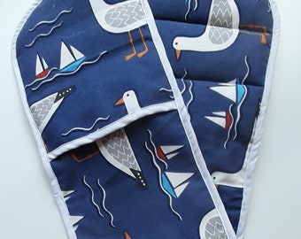 Double oven gloves / pot holder in thick cotton, padded  in Whitby Seagull  design in navy blue with white & red , trimmed in white