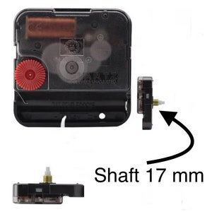 May include: A black quartz clock movement with a red gear and a 17 mm shaft. The clock mechanism has the word "QUARTZ" printed on it. The image shows the front and side views of the clock movement.