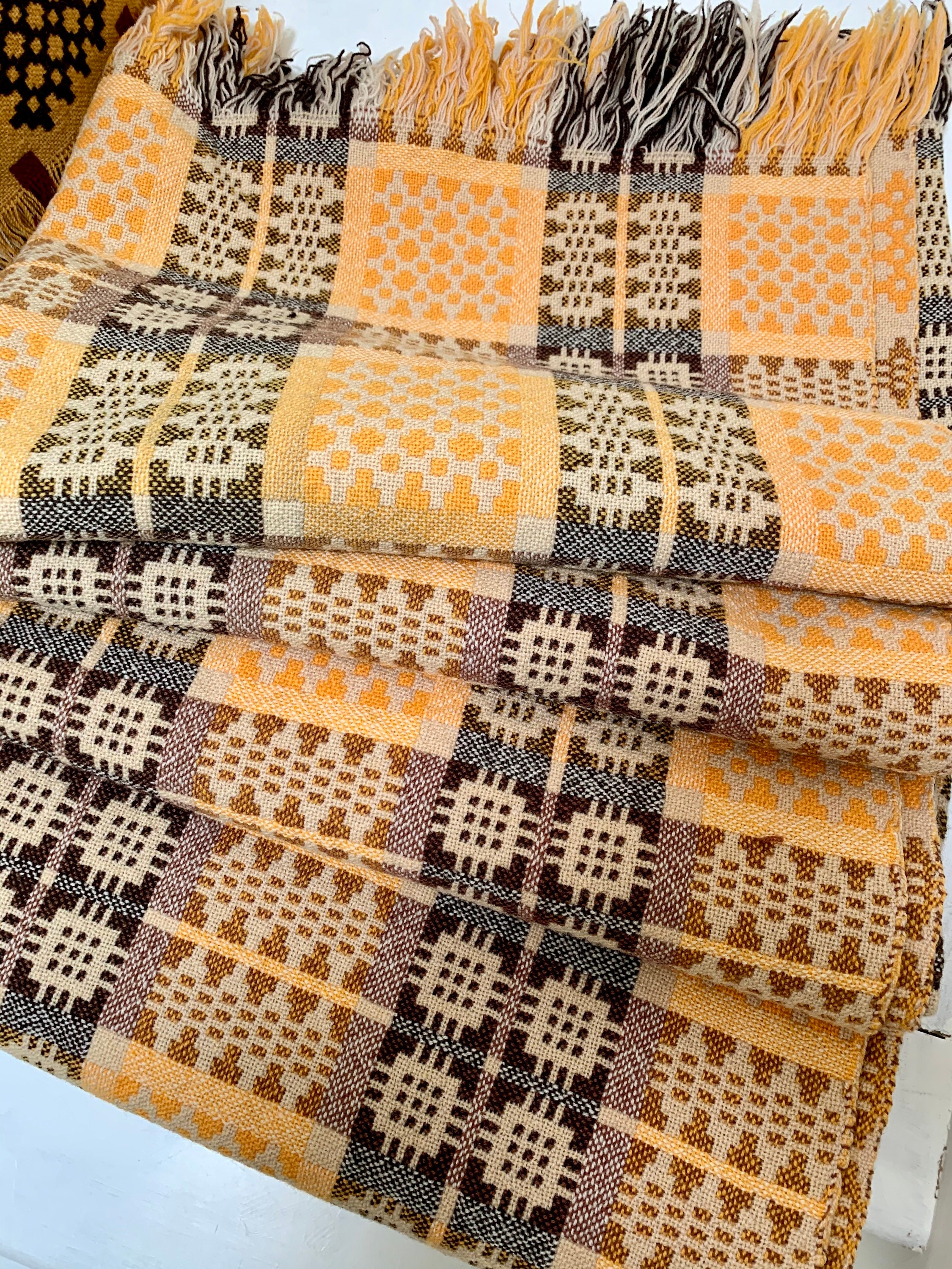 Vintage Welsh tapestry blanket in yellows, browns and creams.
