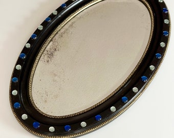 Irish ebonised oval mirror circa 1830 regency period